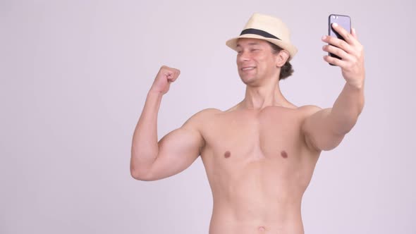 Happy Muscular Tourist Man Smiling While Video Calling with Phone Shirtless