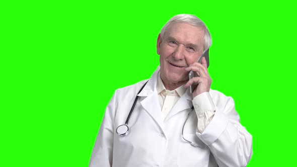 Cheerful Senior Doctor Consulting a Patient on the Phone.