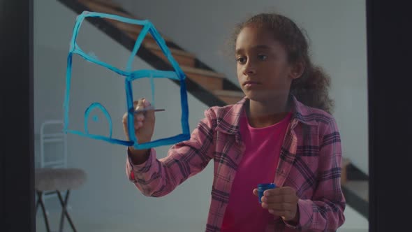 Little Black Artist Painting Dream House on Glass