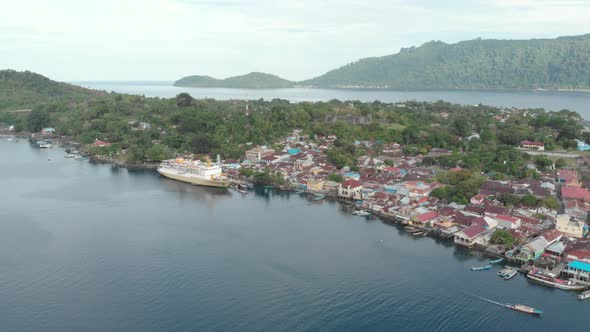 Aerial: flying over passenger ship Pelni in Bandaneira harbor Indonesia