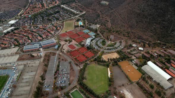 Aerial orbit of a clay tennis court in Las Condes, Santiago, Chile.