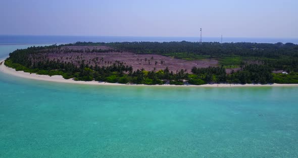 Daytime birds eye abstract view of a sandy white paradise beach and blue water background in 4K