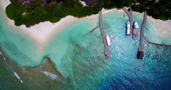 Luxury drone tourism shot of a paradise sunny white sand beach and aqua blue water background in col