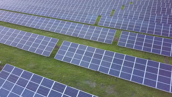 Aerial View of Big Sustainable Electric Power Plant with Many Rows of Solar Photovoltaic Panels for