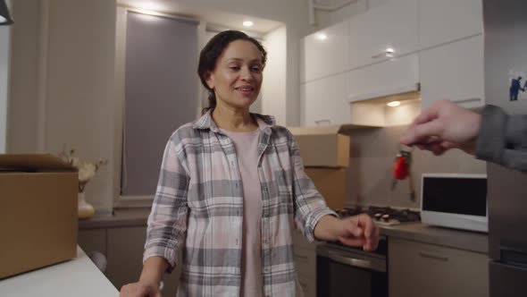 Human Hand Giving Keys From New Apartment to Adult Woman Indoors