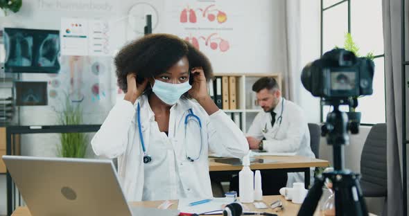 Woman-Doctor Showing How to Wear Protective Mask on Camera