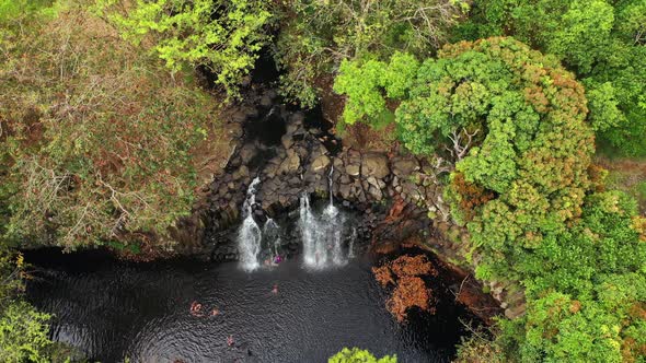 Family on the Background of the Rochester Waterfall on the Island of Mauritius From a Height