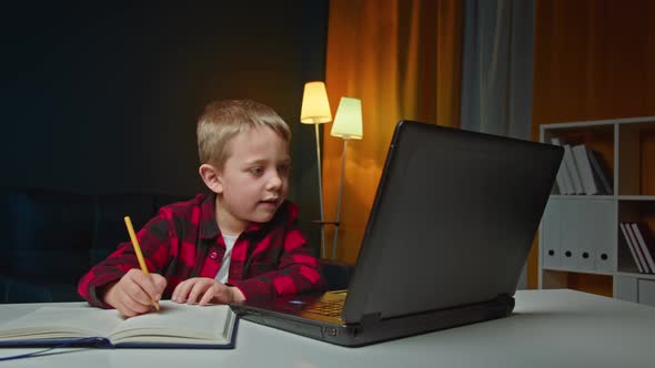 Preschooler Boy Making Online School Homework Using Laptop alt