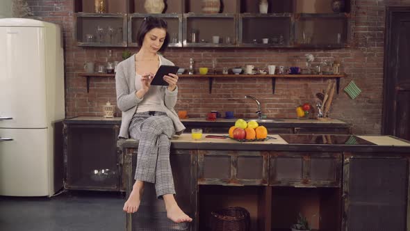 Female with Modern Device Spends Morning in Flat