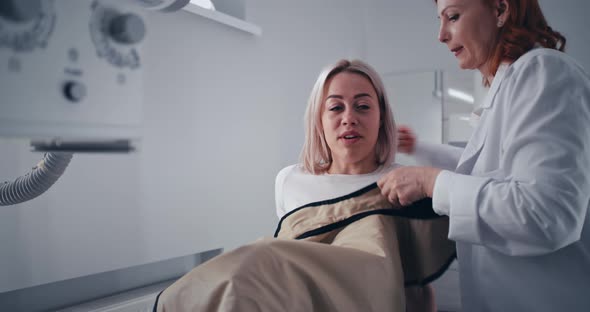 Female Patient Speaking with Doctor During X Ray Scanning Preparation