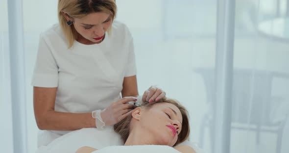 Doctor Trichologist Making Injections Mesotherapy with Vitamins in Woman Skin Head for Hair Growth