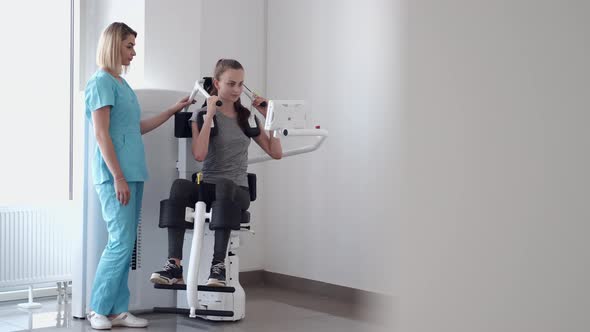 Patient Using Sports Equipment and Doing Exercises in Gym