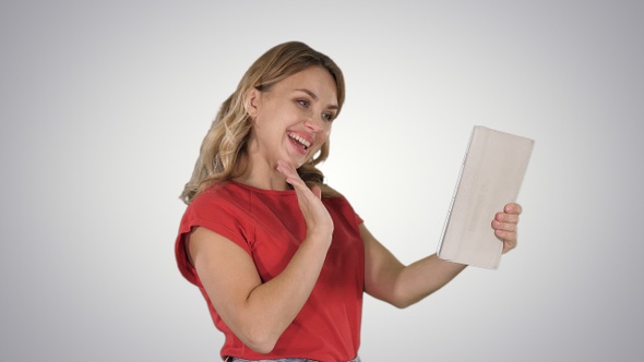 Blonde Young Girl with Tablet in Hand Making a Video Call