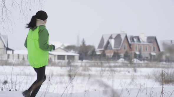 Woman Jogging Outdoors in Winter