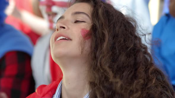 Devoted Female Supporter Chanting Slogans at Football Match