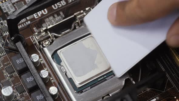 Close Up Shot of Applying Thermal Paste on CPU