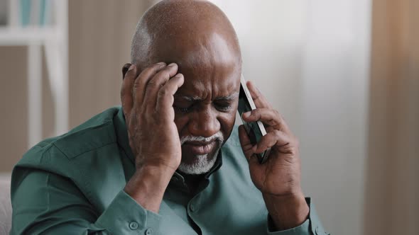 Old Bald African Businessman with Gray Beard Aged Male Client Thinks Speaking on the Phone Remembers