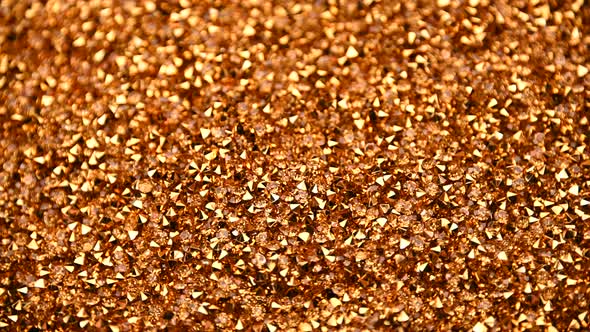 Abstract background of golden rhinestones spinning