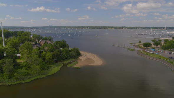 Lowering Aerial Pan of Manhasset Bay and Anchored Boats Seen from Afar