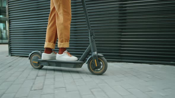 African Man Riding E-Scooter in City