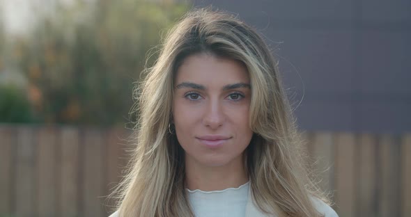 Close Up View of Charming Young Woman with Blond Hair Looking To Camera. Portrait of Female