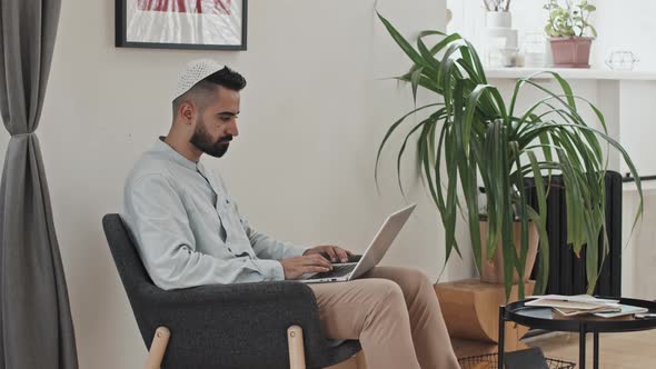 Muslim Man in Kufi Working from Home