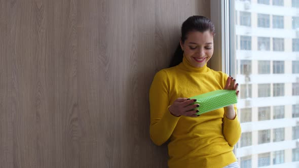 Girl at Home Fiddling with Gifts