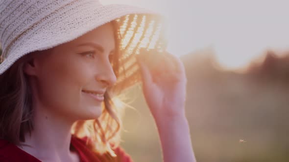 Portrait of Positive Smiling Woman Looking Into Camera at Sunset