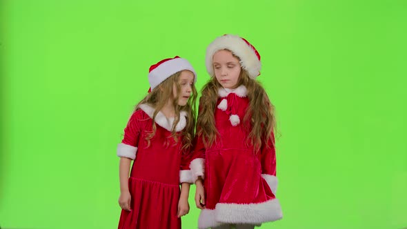 Two Children Girls Swear and Argue, They Are in Colorful Costumes. Green Screen