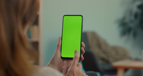 Woman Holding Smartphone and Sliding on Green Screen