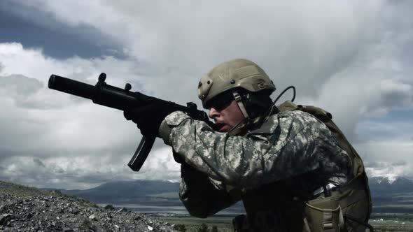 Close up of a soldier with sub-machine gun down, aiming, firing, and lowering weapon.