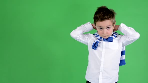 Young Handsome Child Boy Adjusts His Clothes and Smiles To Camera - Green Screen - Studio