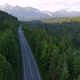 Road trough scenic Forest and wilderness into mountains. Aerial drone fly over road. - VideoHive Item for Sale