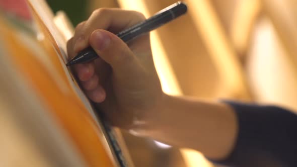 Close Up Artist Paints Picture on Canvas with Marker in Her Workshop