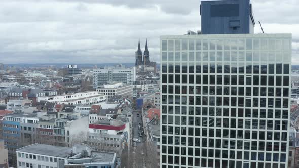 AERIAL: Wide Shot of Cologne Germany From the Air with Majestic Cathedral and Office Building in the