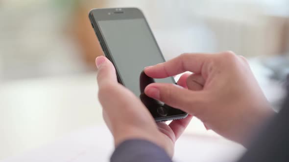 Rear View of Hands of African Woman Using Smartphone