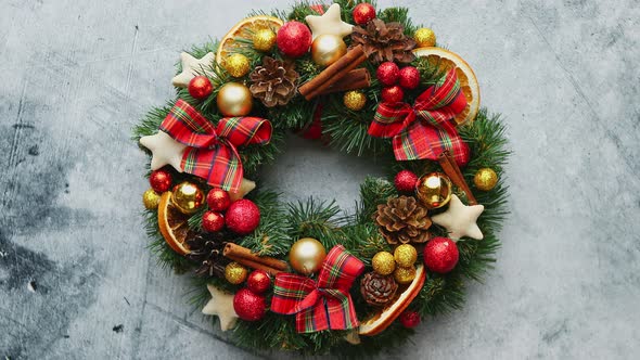 Christmas Green, Red and Golden Wreath with Decorations Isolated on Stone Background