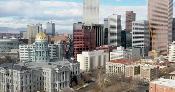 Colorado state capitol and Denver skyline with droneing up.