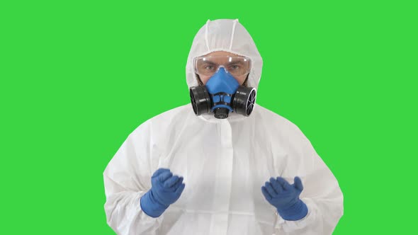 Doctor in Hazamat Protective Suit Dancing in a Funny Way Covid-19 Concept on a Green Screen, Chroma