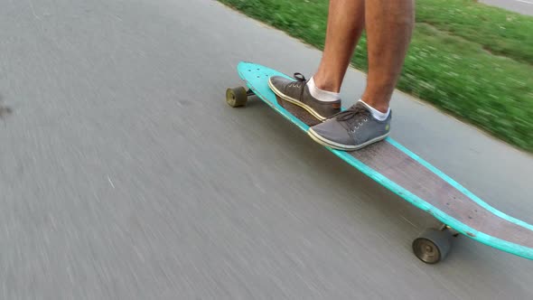 Close up of legs on longboard