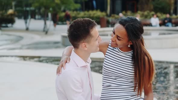 Close-up of Cheerful Multiracial Couple Having Date in a Beautiful Park