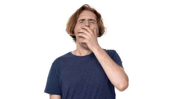 Portrait of Sleepy Man Having Insomnia Yawning and Covering Open Mouth with Hand Isolated Over White