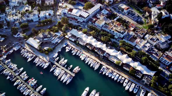 View from drone on full of yachts Bodrum harbour and ancient Kalesi castle in Mugla in Turkey