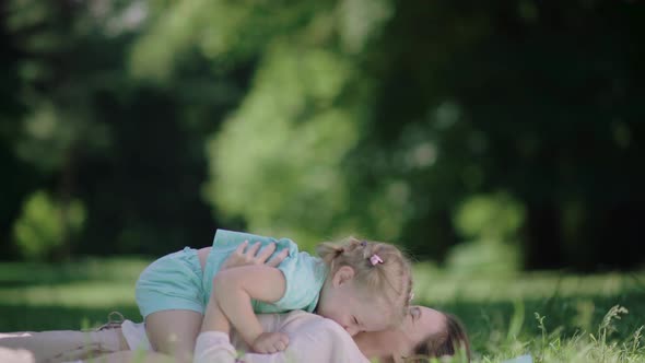 Family Fun. Mother And Daughter Playing And Laughing In Park