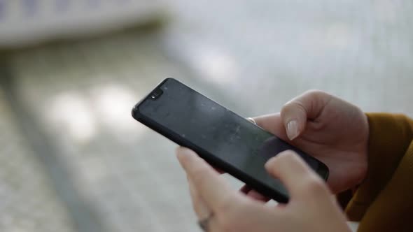 Cropped Shot of Girl Texting Via Smartphone