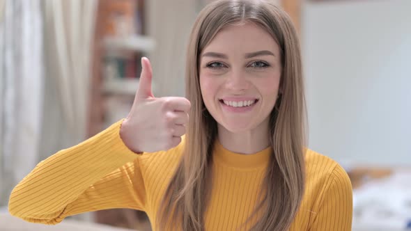 Portrait of Young Woman Showing Thumbs Up