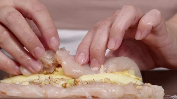 Chef Forms a Roll of Chicken Fillet