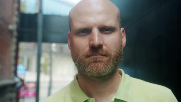 Closeup Slow Motion Portrait of Attractive Bald Guy with Reddish Beard Outdoors in Urban Street