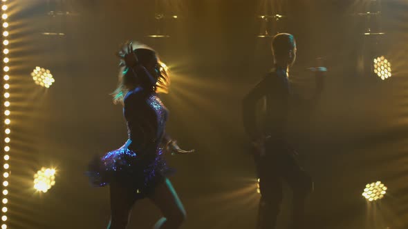 Rumba Drive Dance Performed By a Young Pair of Ballroom Dancers