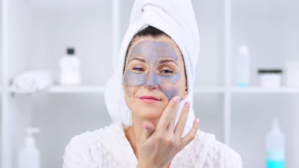 Cute Young Girl Making Gray Mask on Her Face